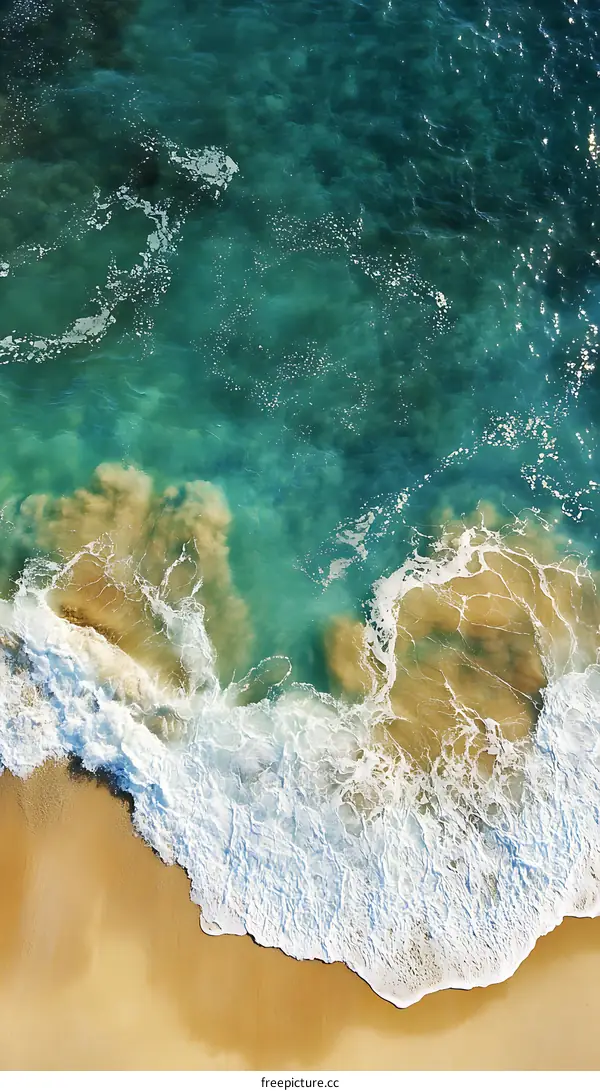 Aerial View of Ocean Waves Crashing on Sandy Beach