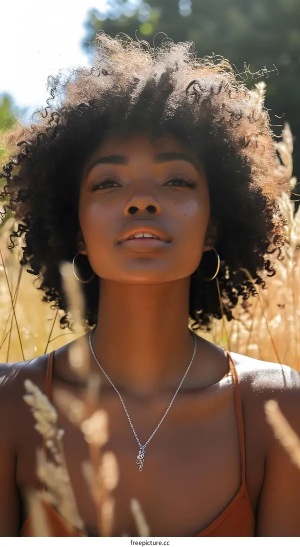 portrait of a young woman with curly hair and freckles