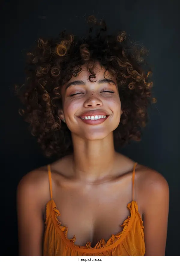 portrait of a smiling woman with curly hair