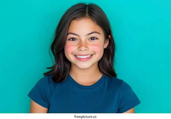 Smiling Girl Portrait Against Teal Background