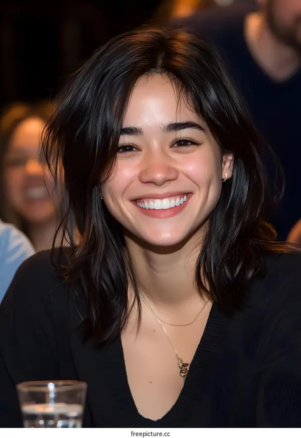 Smiling Woman with Long Black Hair and White Teeth
