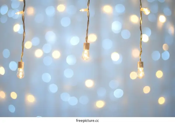 Warm Light Bulbs Hanging Against a Soft Blue Bokeh Background