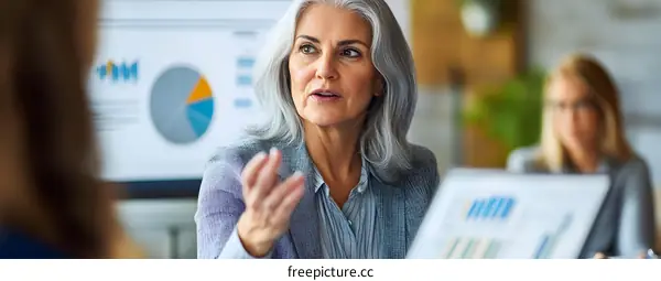 Businesswoman Discussing Strategy with Team in Meeting