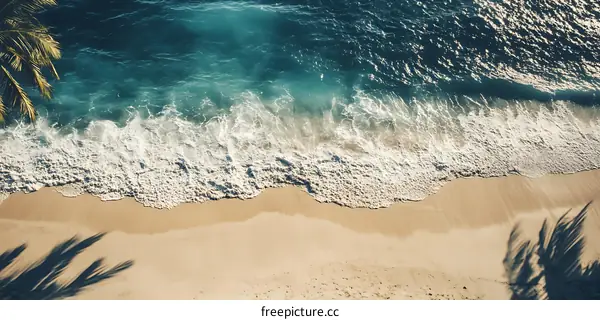 Aerial View of Waves Crashing on Sandy Beach