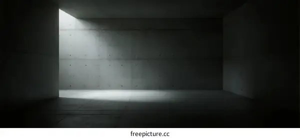 Dark empty concrete room with a small light source coming from the top left corner