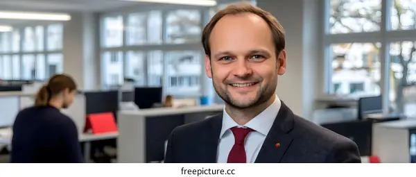 Smiling Businessman in Modern Office Setting