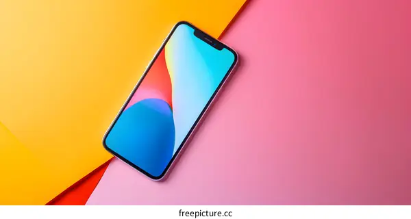 Smartphone with colorful abstract background on pink and yellow surfaces