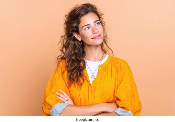Thoughtful Woman in a Vibrant Orange Blouse