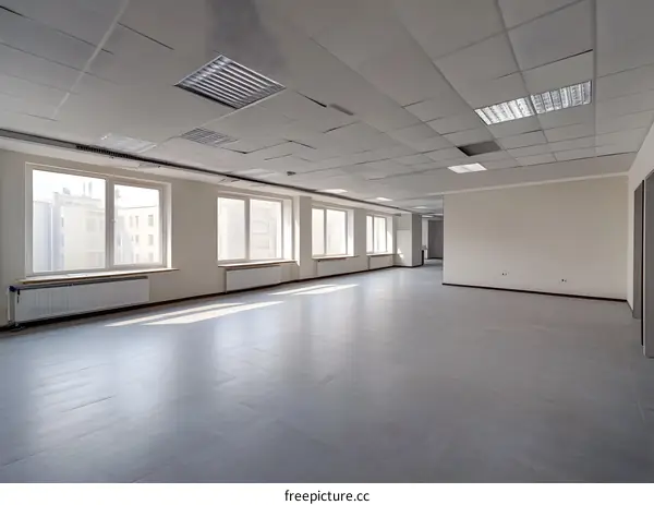 Empty Office Space with Windows and Grey Tiles