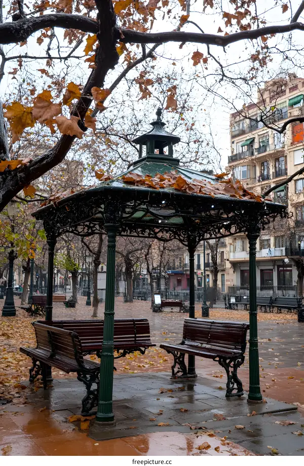 Autumn Leaves on a Bench in a Park Gazebo