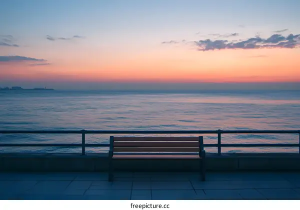 Lonely Bench Facing the Sea at Sunrise
