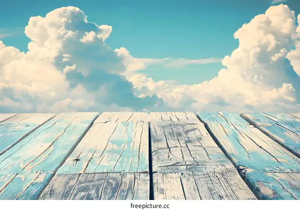 Wooden Plank Against Blue Sky with Clouds