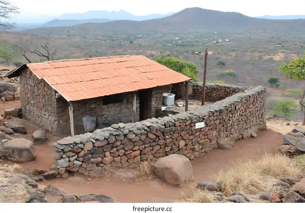 Stone House in Rural Landscape with Mountains in the Background