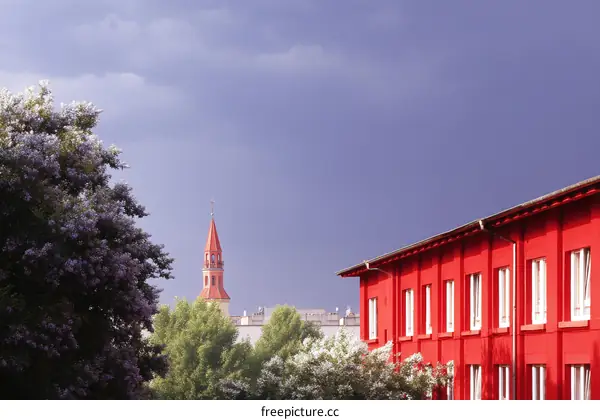 Red Building with a Tower in a Cloudy Sky