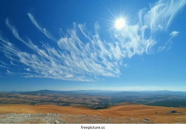 Cirrus clouds over a mountain landscape