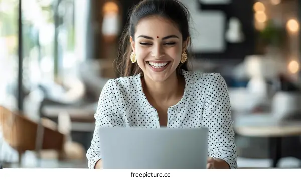 Happy Woman Working on Laptop in Cafe