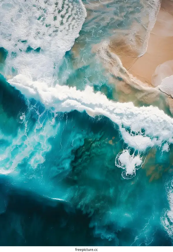 Aerial View of Ocean Waves Crashing on Sandy Shore
