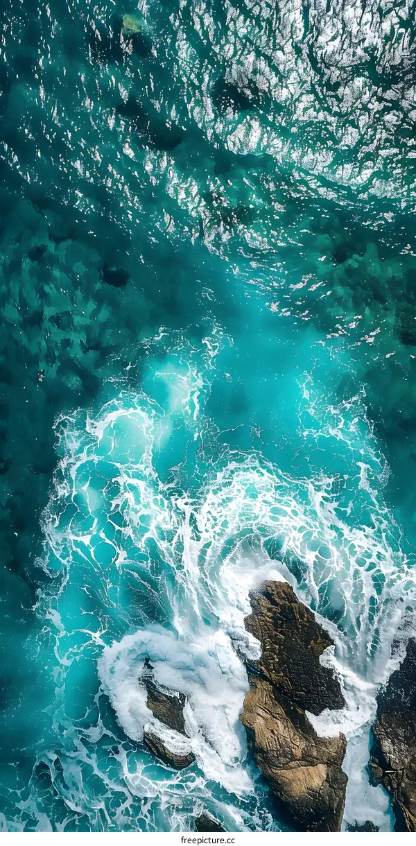 Aerial View of Ocean Waves Crashing on Rocks