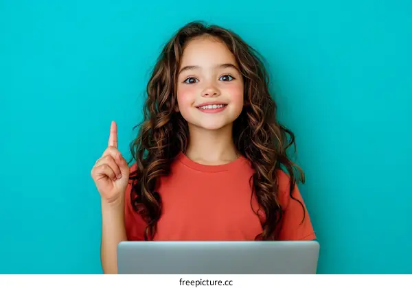 Smiling Girl with Curly Hair Pointing at Idea on Laptop
