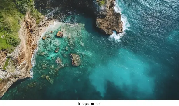 Aerial View of the Turquoise Ocean with Rocky Coastline
