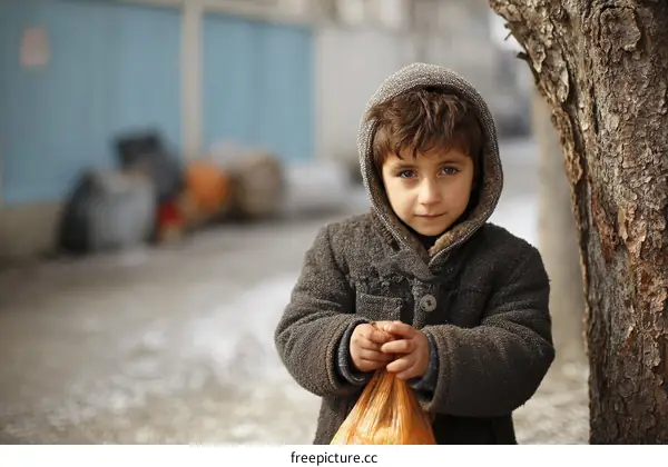 Street Child Holding a Bag in Winter