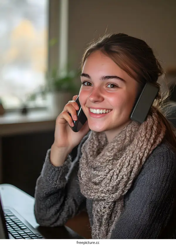 Smiling Woman Talking on Phone While Working from Home