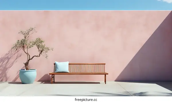 Pink wall with a bench and a tree