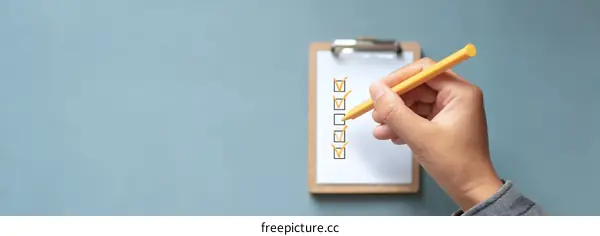 Checklist and Hand with Pen