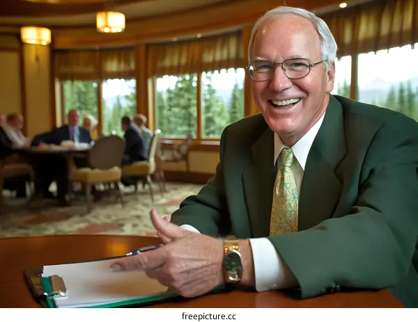 Smiling Businessman in Green Suit at Meeting
