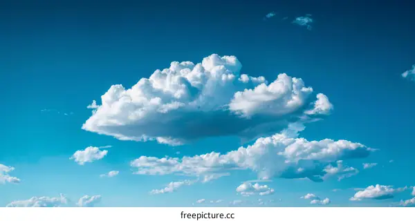Fluffy white clouds dot a gorgeous azure sky