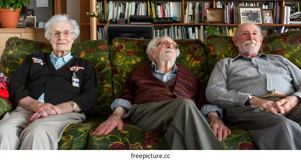 Three Senior Citizens Sitting On A Couch