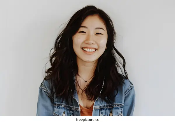 Smiling Asian Woman Wearing Denim Jacket