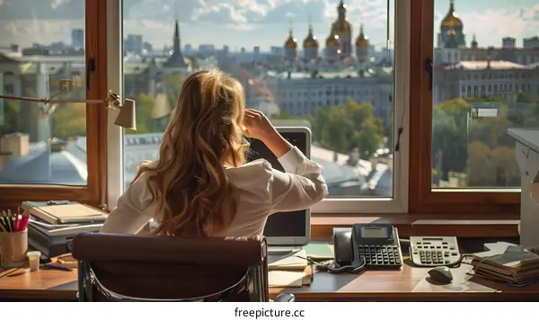 Businesswoman looking out of the office window
