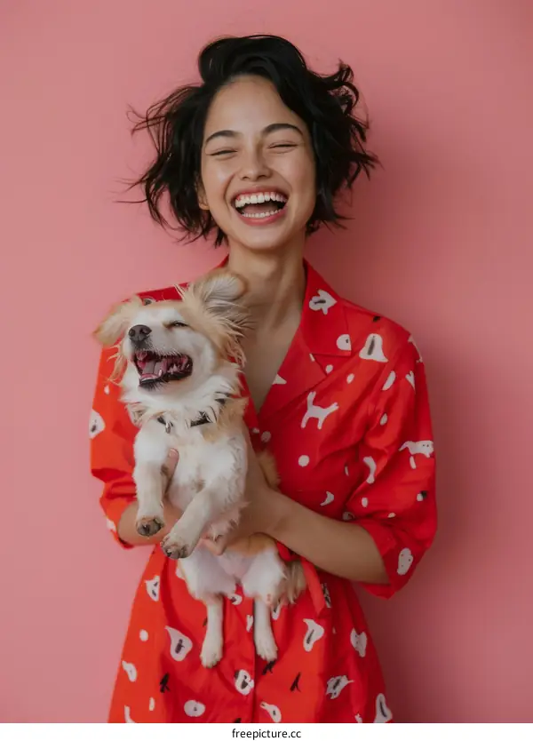 Laughing woman holding a small dog