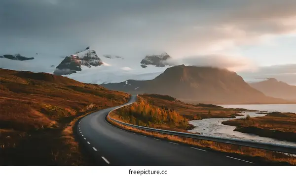 Scenic winding road through mountainous landscape with autumn colors