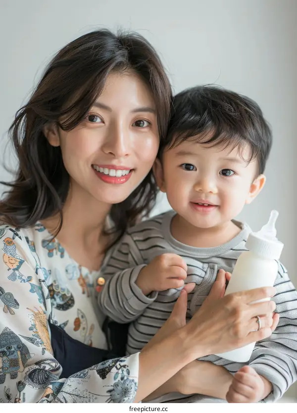 Asian mother holding her baby boy