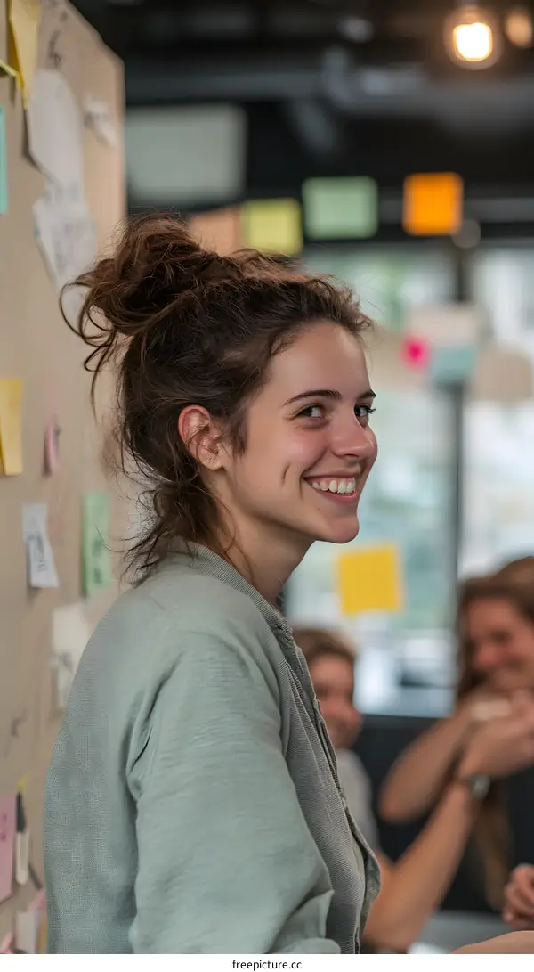 Smiling Woman With Messy Bun In A Green Sweater