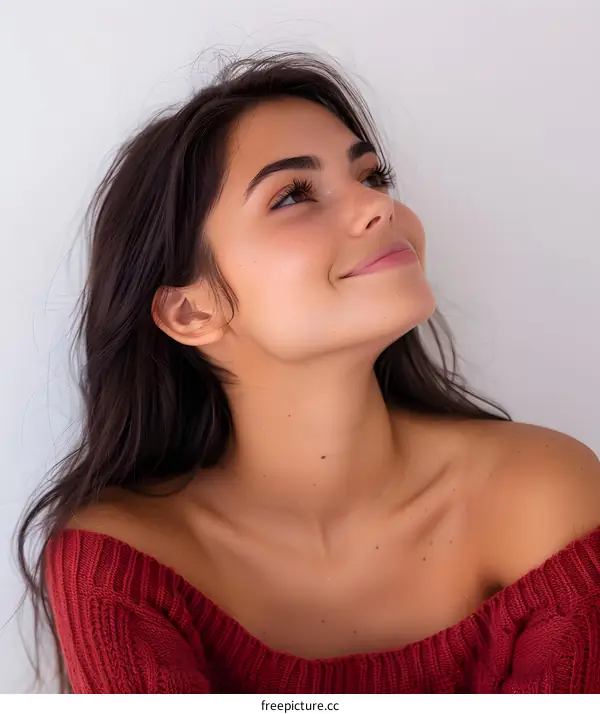 Portrait of a young woman with freckles looking up