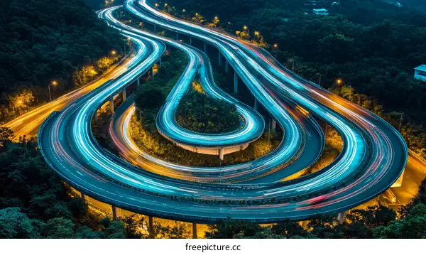 Nighttime Highway Curves Overlooking Cityscape