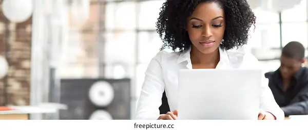 African American Woman Using Laptop in Office