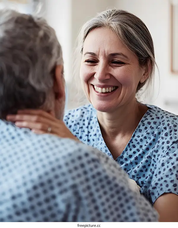 Woman In Hospital Gown Smiling at Man