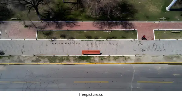 Aerial View of a City Street with a Red Bench and a Person