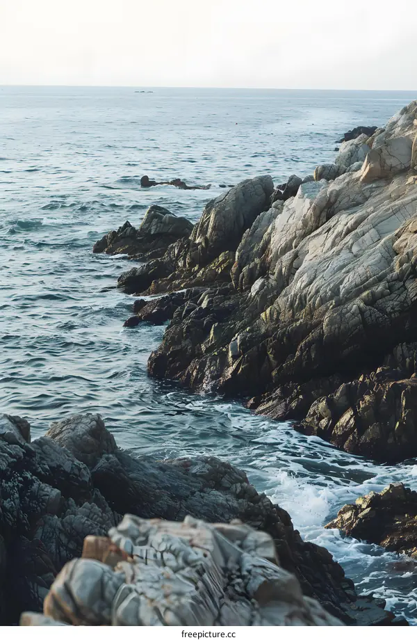 Ocean Waves Crashing Against Rocky Coastline