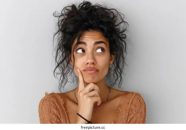 Thoughtful Woman Portrait Against a Light Gray Background