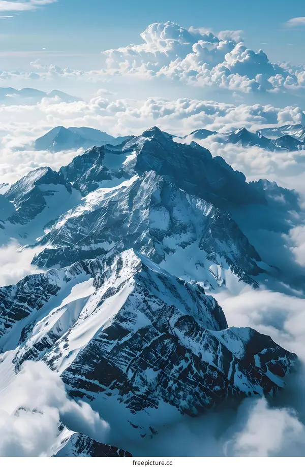 Aerial View of Snowy Mountains with Clouds