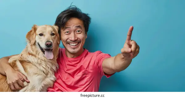 Asian man with a golden retriever dog