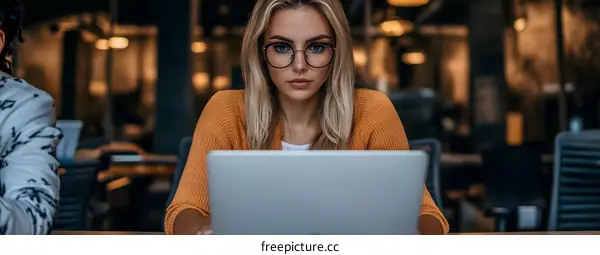 Young Woman Working on Laptop in Office
