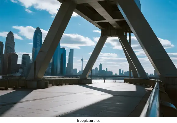 Modern cityscape with bridge structure under clear blue sky