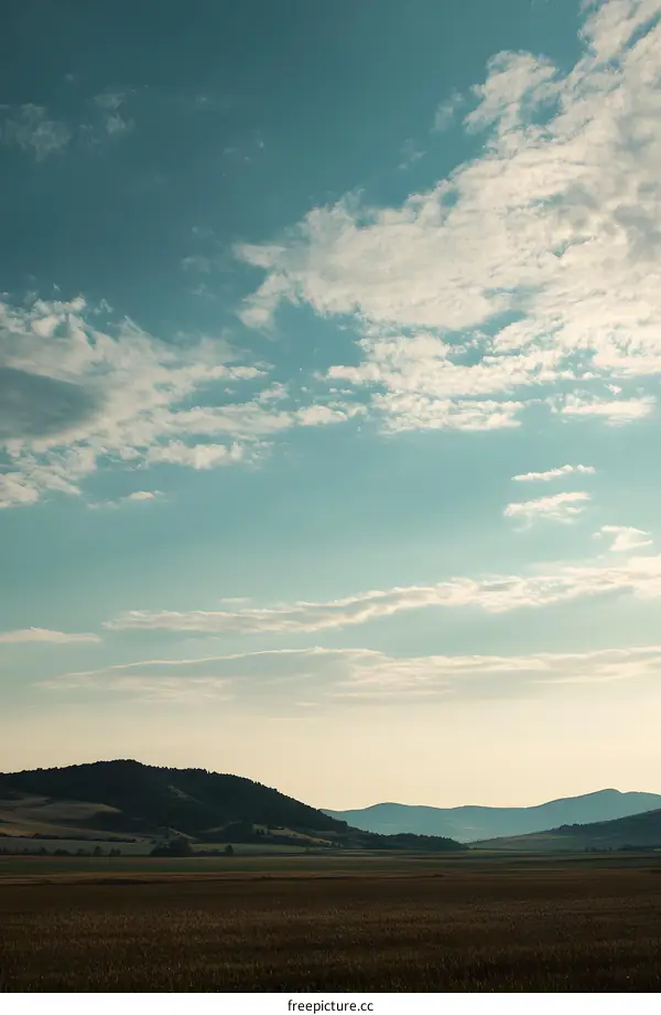Picturesque View of a Rolling Hills Landscape Under a Blue Sky