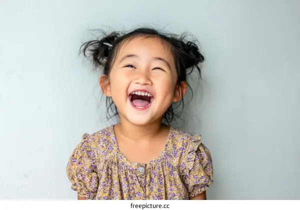 Joyful Little Girl Smiles and Laughs